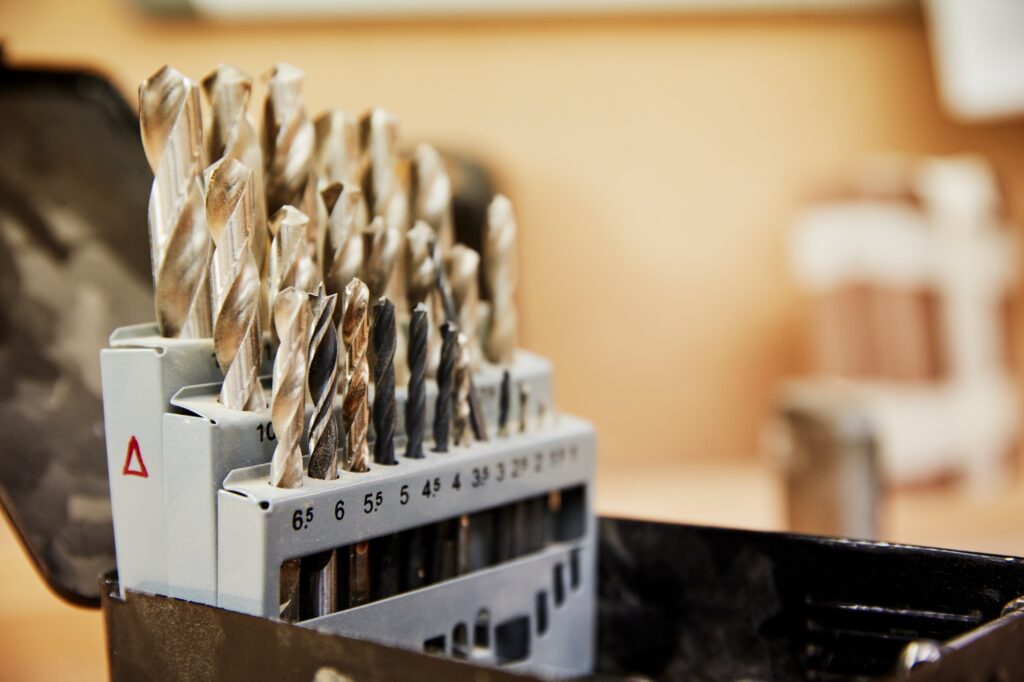 A furniture workshop. Drill bits arranged in a box neatly.