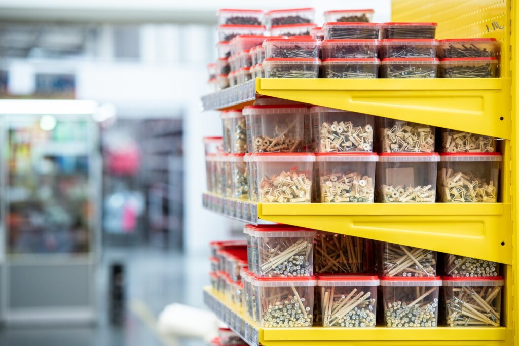 Shelves with nails in plastic containers in hardware store